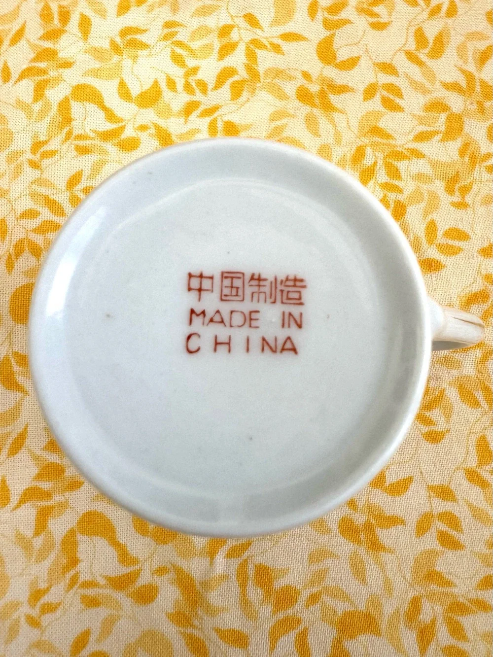 Vintage Espresso Cup and Matching Saucer. White Porcelain with Floral Motif.